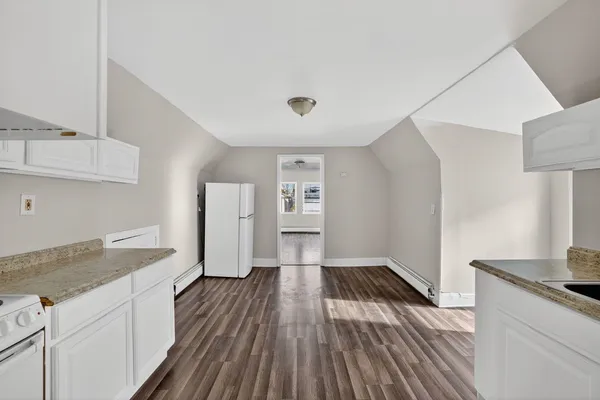 a kitchen with sink and refrigerator
