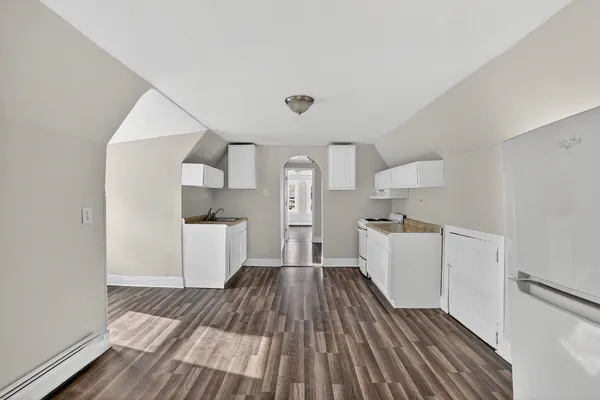 a view of a kitchen with wooden floor