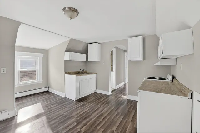 a kitchen with stainless steel appliances a refrigerator sink and cabinets
