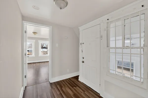 a view of a hallway with wooden floor