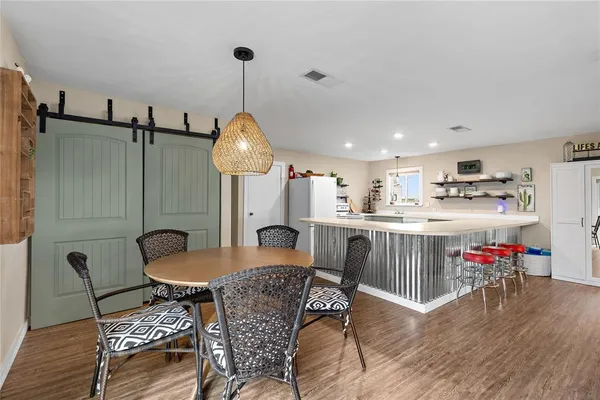 a dining room with furniture and wooden floor