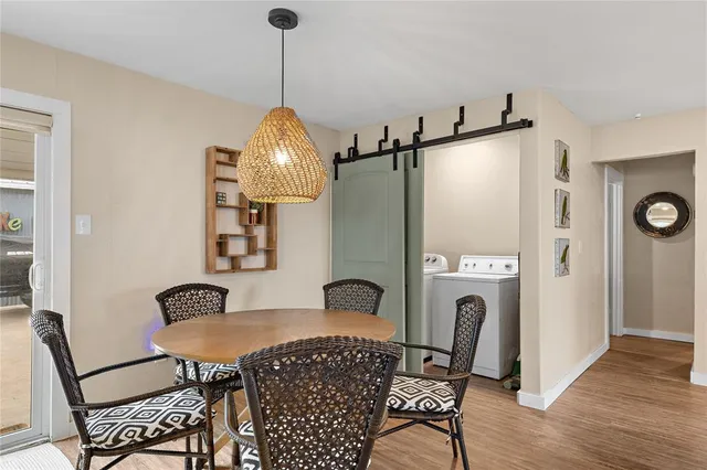 a view of a dining room with furniture and wooden floor