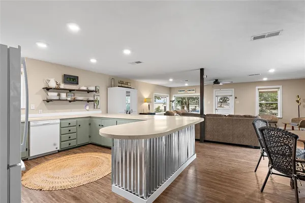 a large dining hall with stainless steel appliances granite countertop a stove and a sink