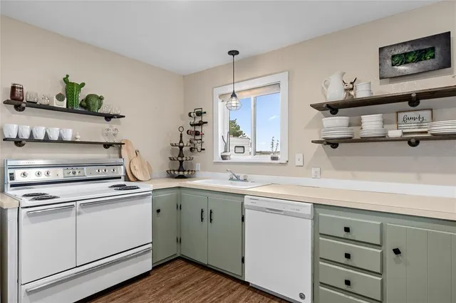 a kitchen with stainless steel appliances white cabinets and a sink