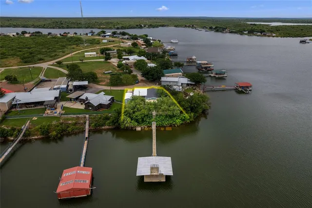 an aerial view of a house with a lake view