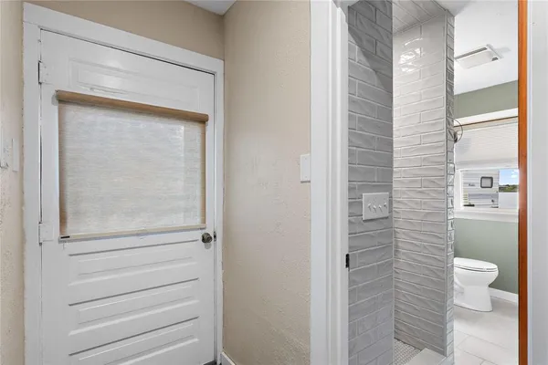 a bathroom with a toilet and a shower