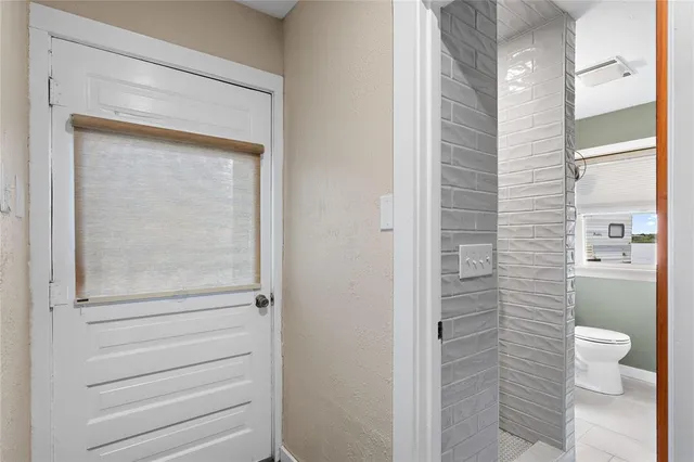 a bathroom with a toilet and a shower