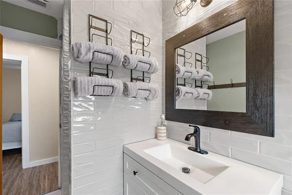 a bathroom with a sink and mirror