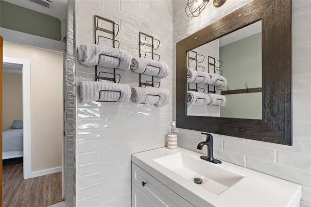 a bathroom with a sink and mirror