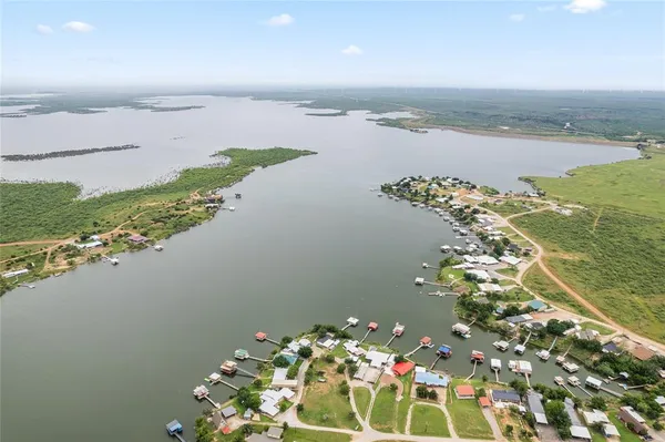 an aerial view of a house with a lake view