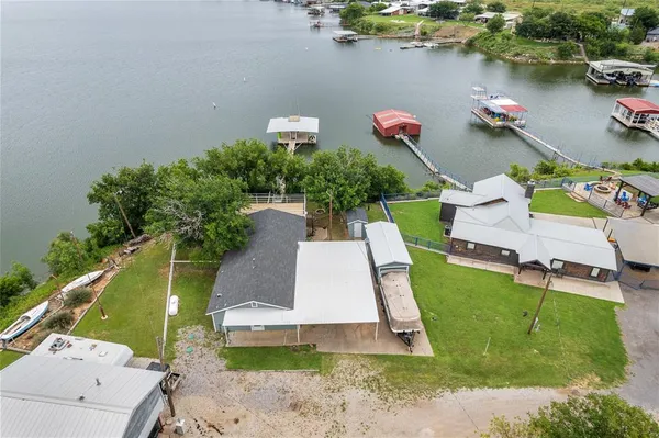 an aerial view of a house with a garden and lake view
