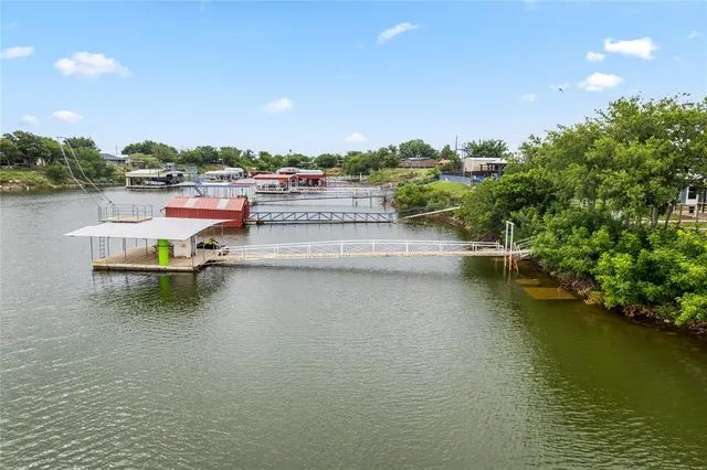 a view of a lake with boats and trees in the background