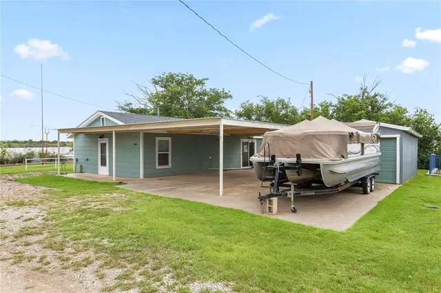 a view of a house with a yard patio and sitting area