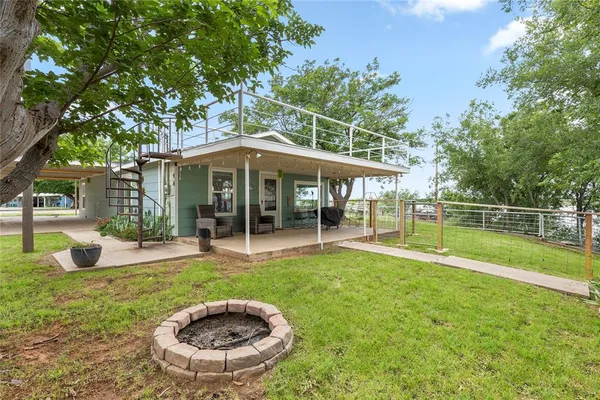 a view of a house with a backyard porch and sitting area