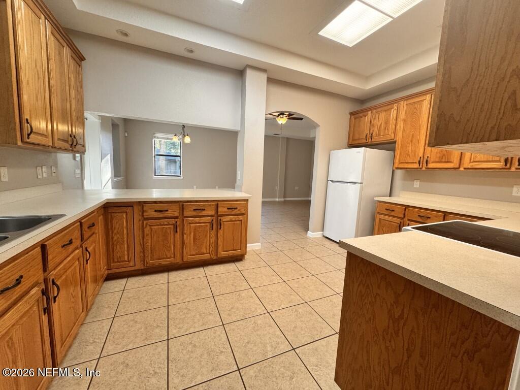 1467 Rivers Road Green Cove Springs, FL 32043 - Photo 6 of 22 a kitchen with a sink a refrigerator and cabinets