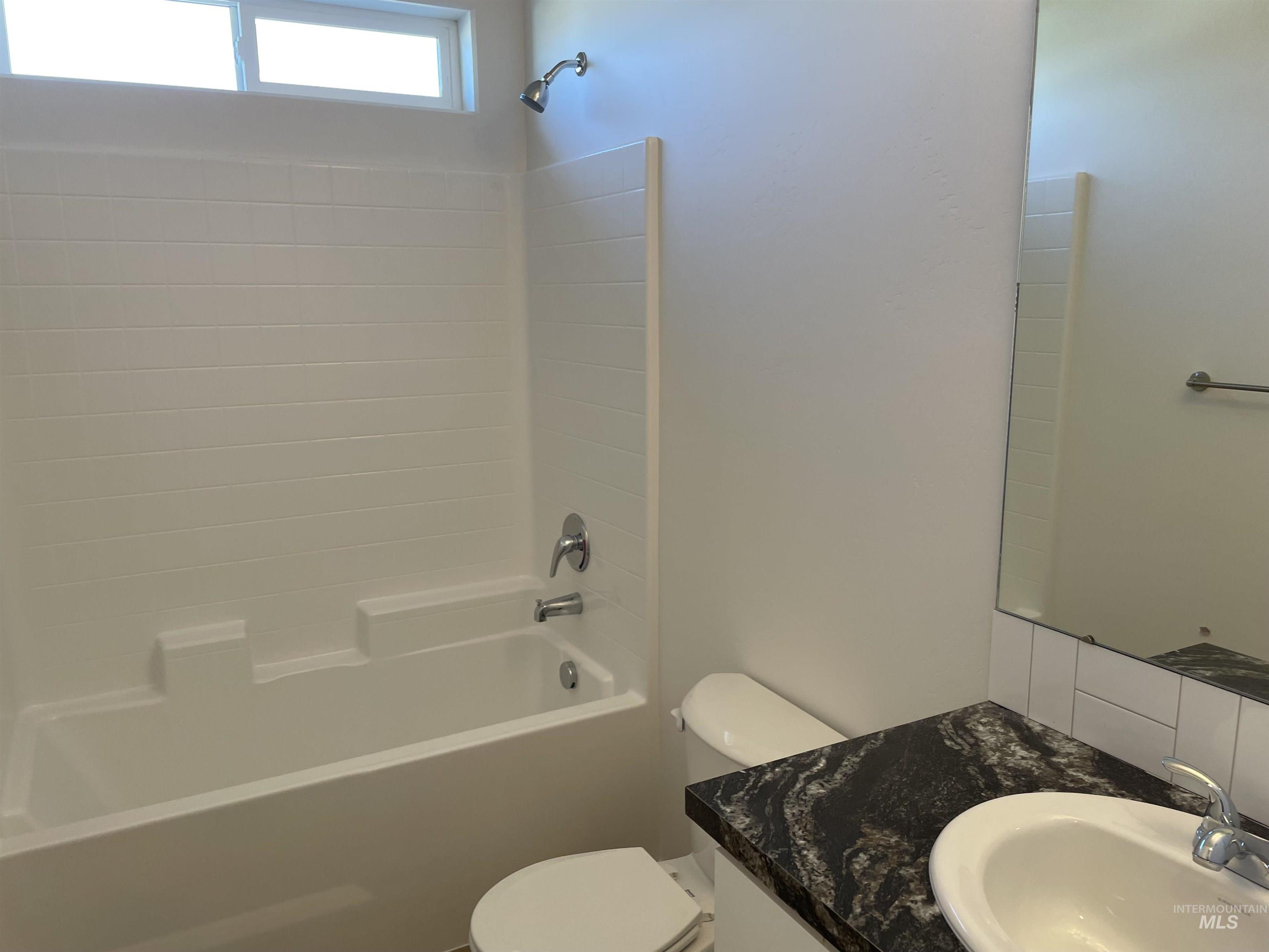 1333 Luther Road Jerome, ID 83338 - Photo 7 of 9 Bright interior space featuring light-colored walls and contrasting carpet flooring
