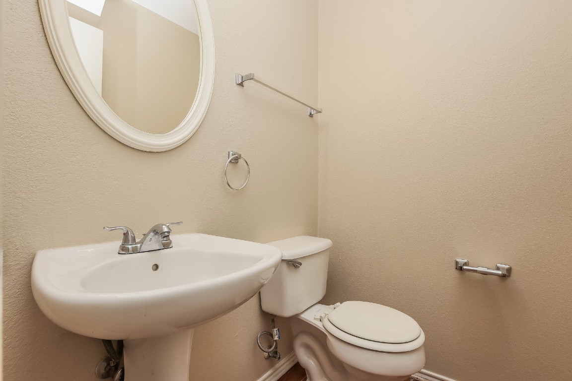4311 Cisco Valley Drive Round Rock, TX 78664 - Photo 14 of 18 a bathroom with a sink a mirror and a toilet