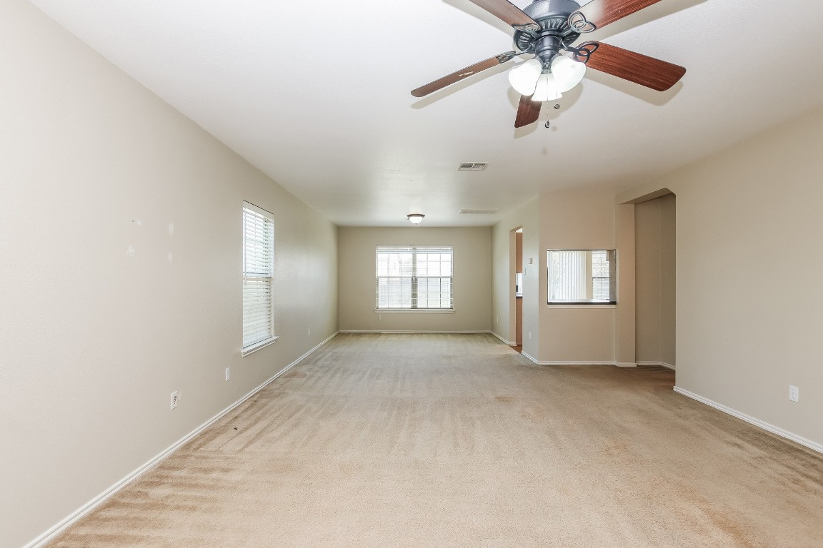 4311 Cisco Valley Drive Round Rock, TX 78664 - Photo 5 of 18 an empty room with chandelier fan and windows