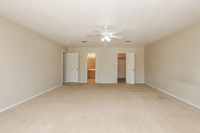 a large kitchen with stainless steel appliances wooden cabinets and a sink