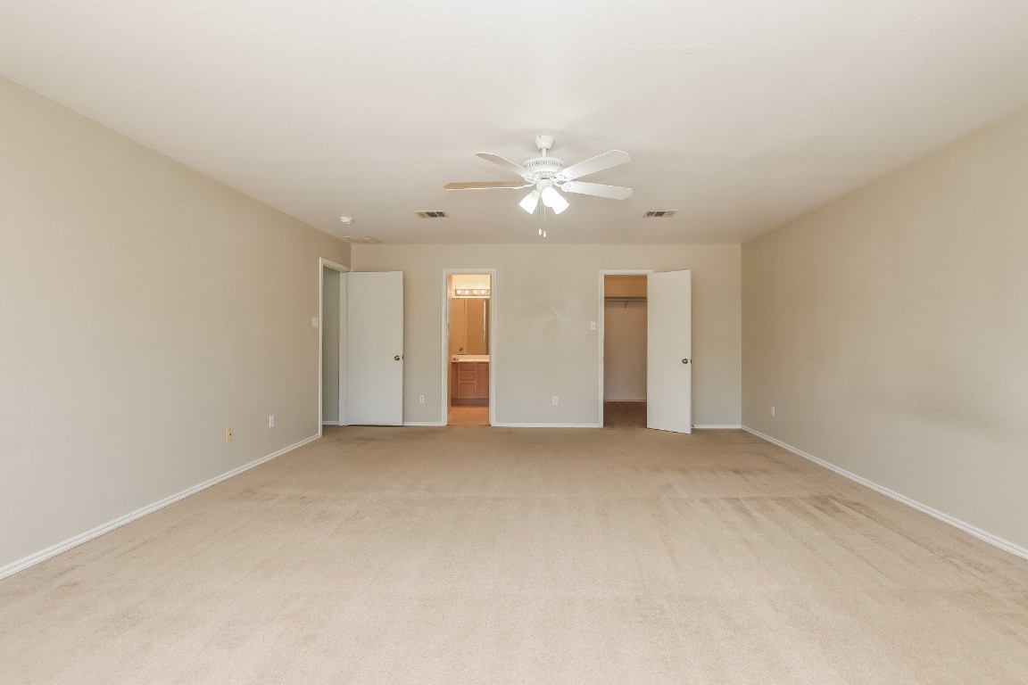 4311 Cisco Valley Drive Round Rock, TX 78664 - Photo 9 of 18 an empty room with chandelier fan and windows