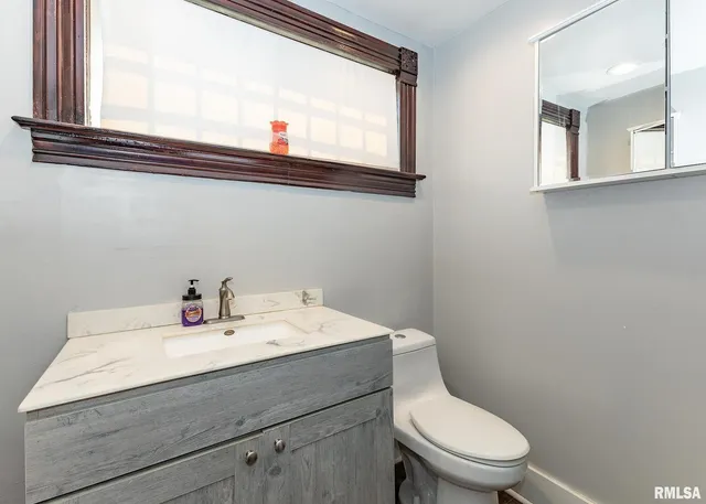 a view of a livingroom with wooden floor and staircase