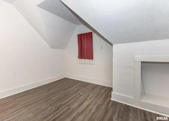 a view of a room with wooden floor and closet