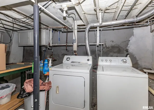 a backyard of a house with large trees and wooden fence