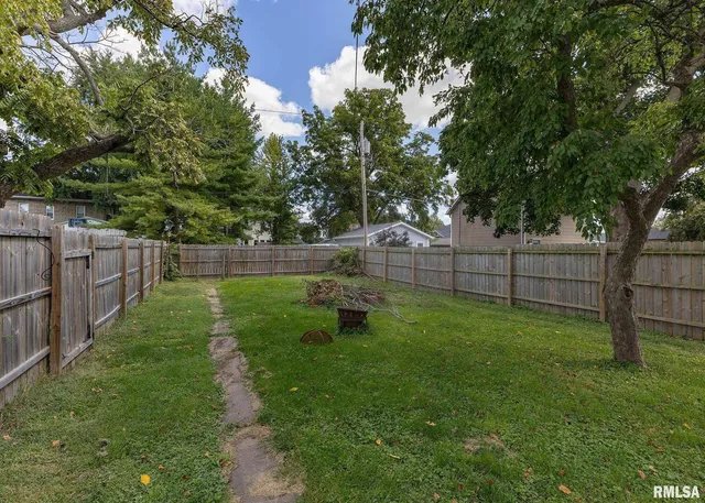 a view of a chairs and table in backyard of the house