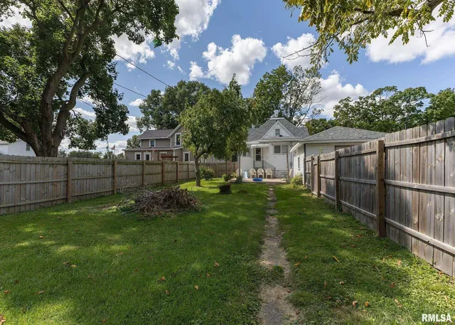 a view of a backyard with plants and patio