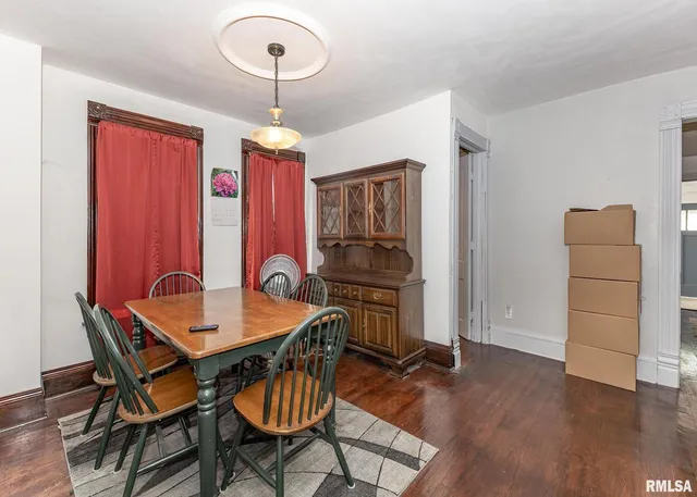 a kitchen with stainless steel appliances granite countertop a kitchen island a stove a table and chairs