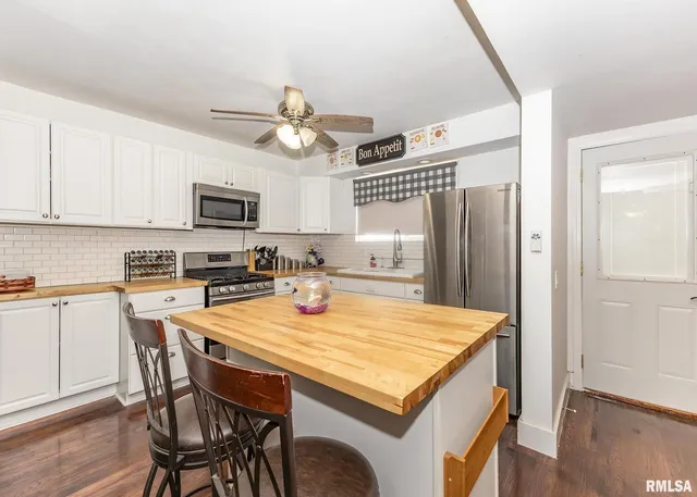 a kitchen with granite countertop a stove sink and cabinets