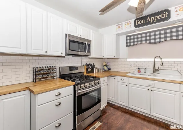 a kitchen with refrigerator and sink