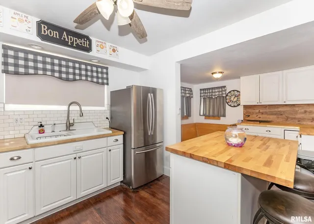 a kitchen with a stove a sink and a refrigerator