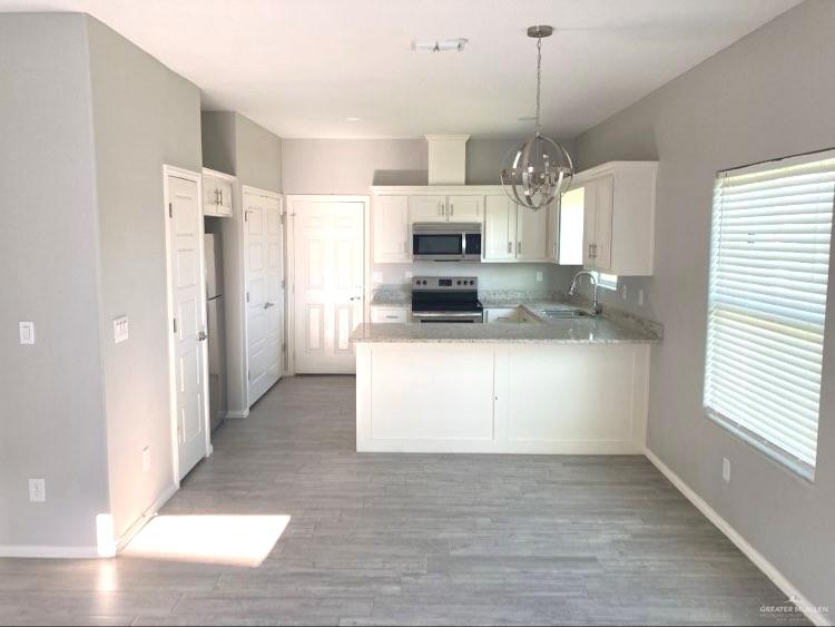 1904 Davenport Street, Unit 4 Weslaco, TX 78596 - Photo 6 of 11 a kitchen with a refrigerator sink and cabinets