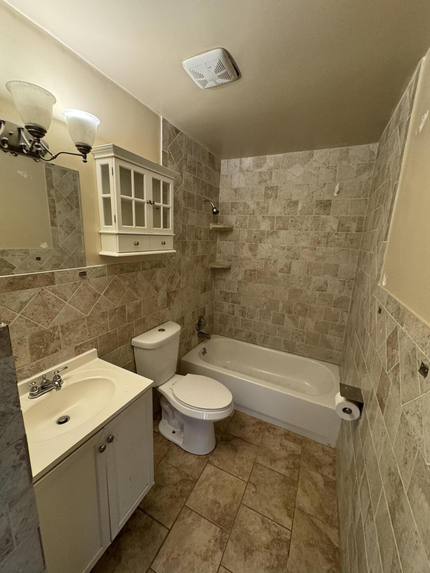 10115 Patience Lane Royal Palm Beach, FL 33411 - Photo 2 of 8 a bathroom with a toilet sink and mirror