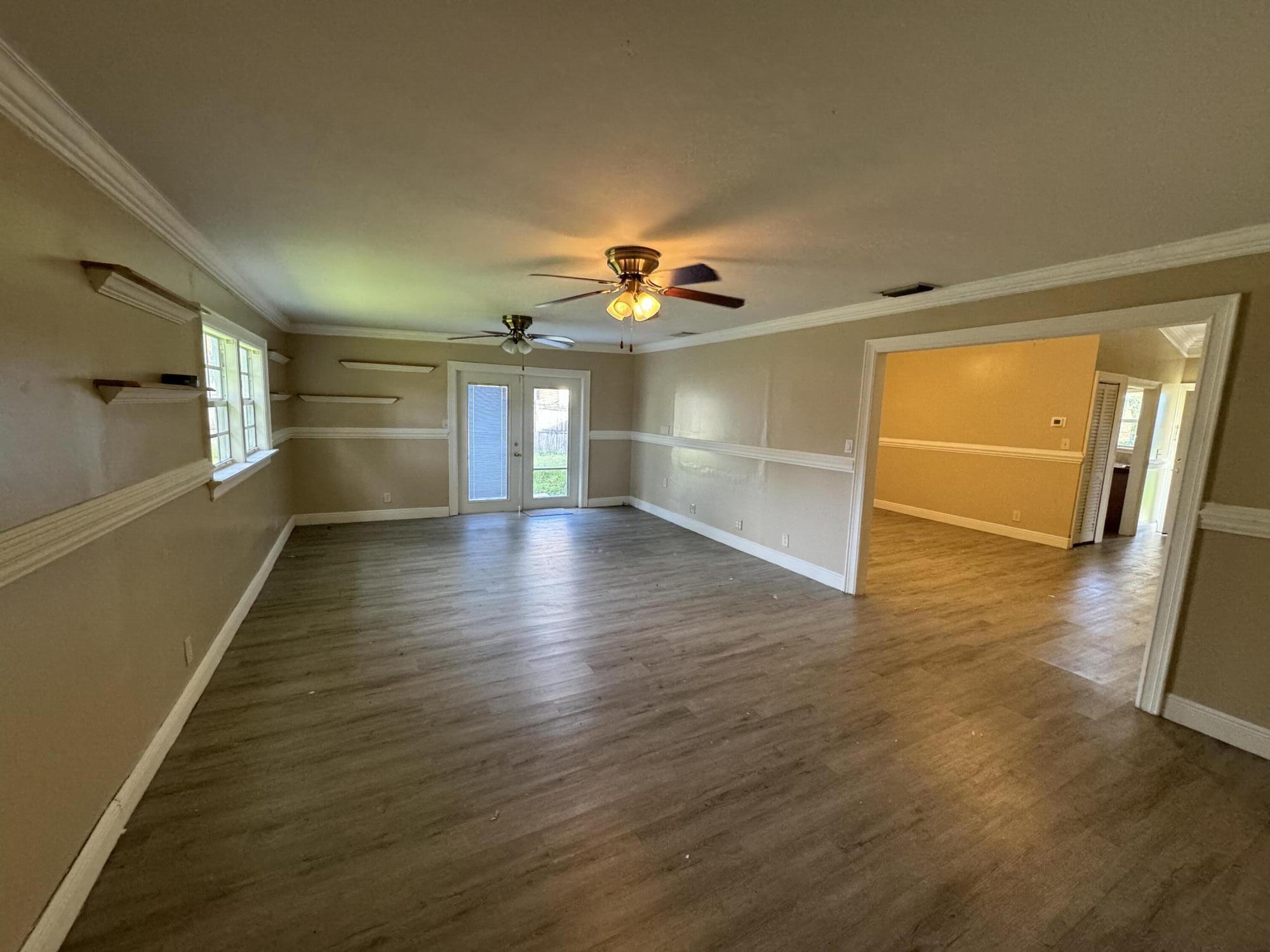 10115 Patience Lane Royal Palm Beach, FL 33411 - Photo 6 of 8 a view of empty room with wooden floor and fan