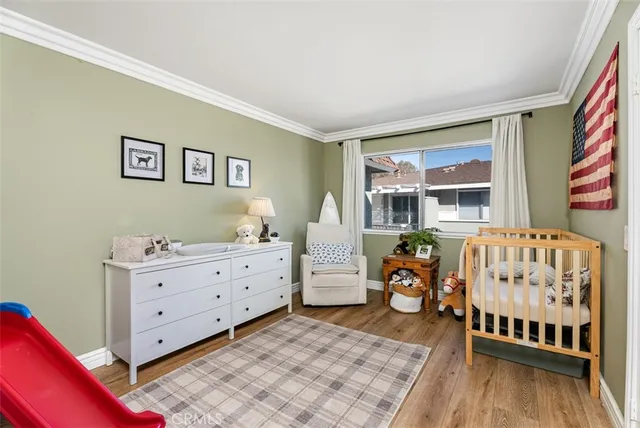 a bedroom with furniture and a wooden floor