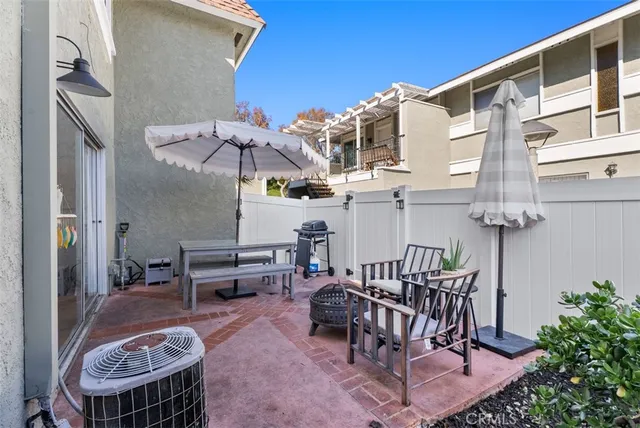 a view of a patio with couches table and chairs and potted plants