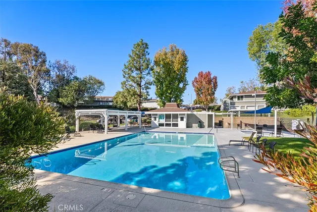 a view of a house with pool and chairs