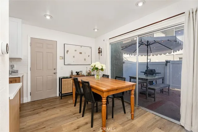 a dining room with furniture and wooden floor