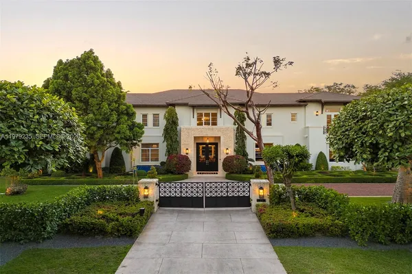 a front view of a house with a garden