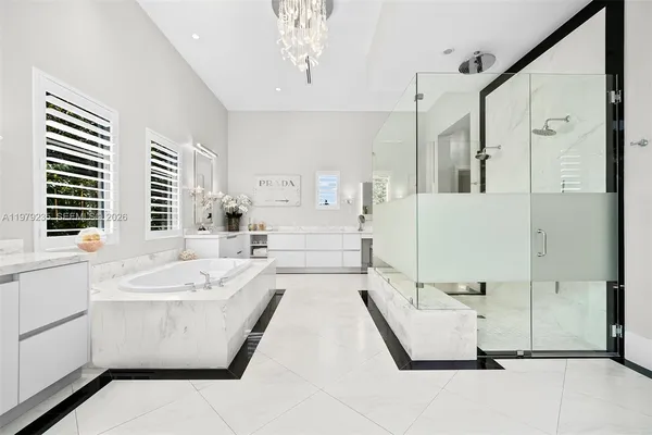 a bathroom with a tub sink and mirror
