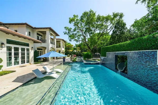 a view of backyard with swimming pool and outdoor seating