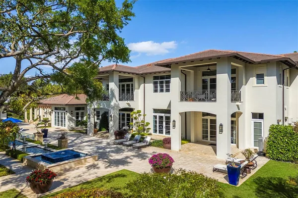 an aerial view of a house with yard and outdoor seating