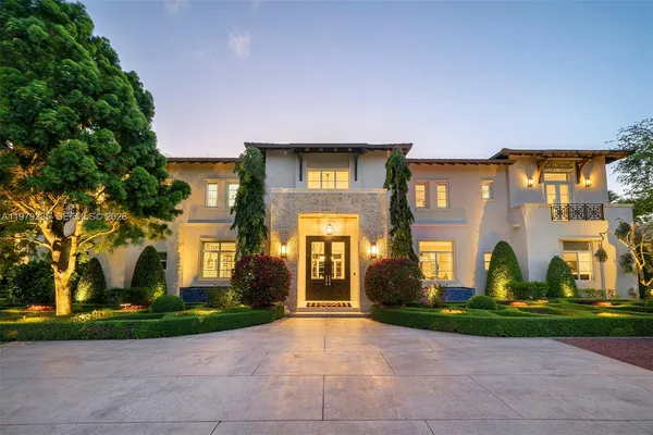 a front view of a house with sitting area and garden