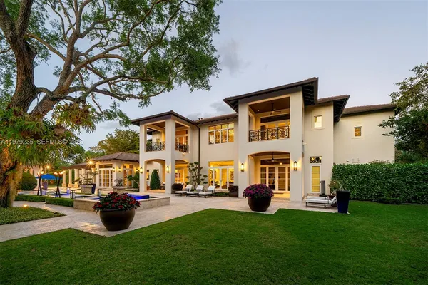 a front view of house with outdoor seating and green space