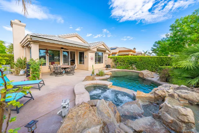 a view of house with outdoor space and sitting area