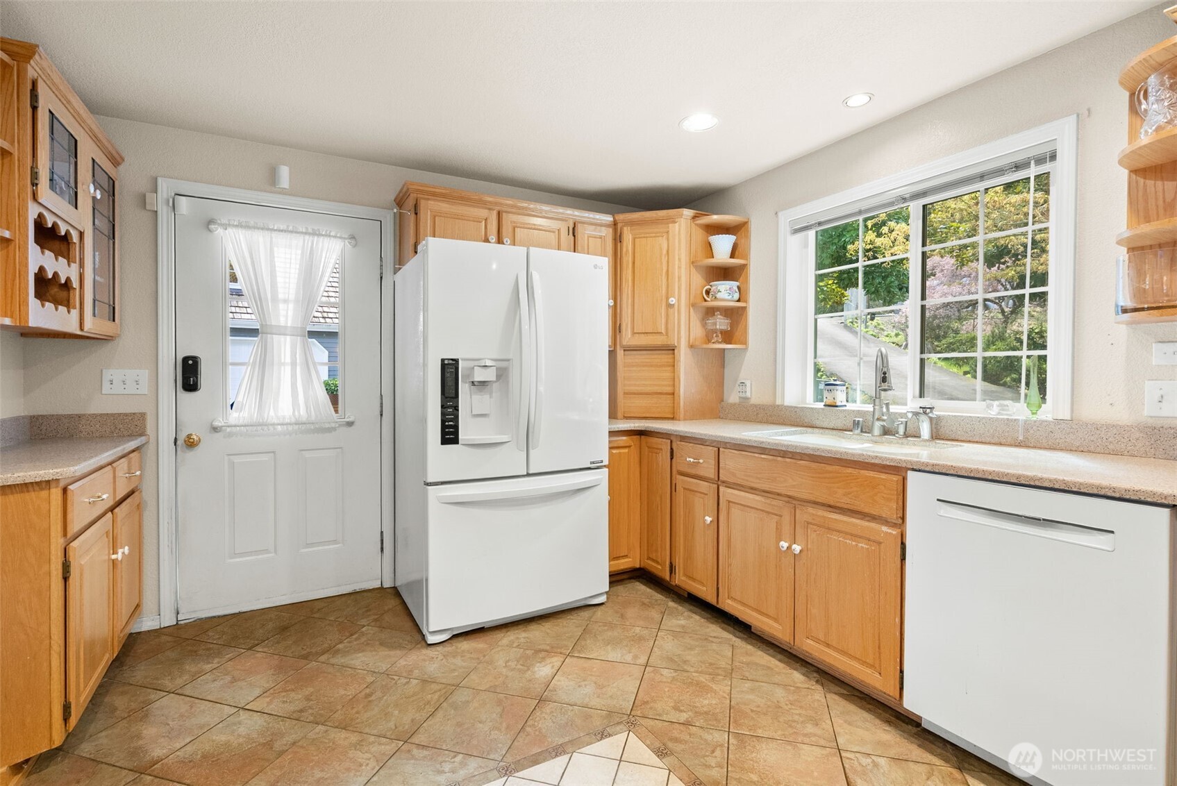 8320 East Grapeview Loop Road Allyn, WA 98524 - Photo 9 of 38 a kitchen with a refrigerator and white cabinets