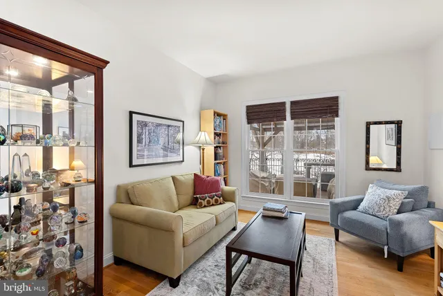 a view of a livingroom with workspace and a window