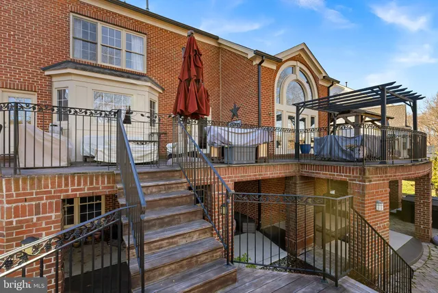 a view of a dining room with furniture a rug and wooden floor
